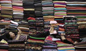 Women lie on coloured cloth